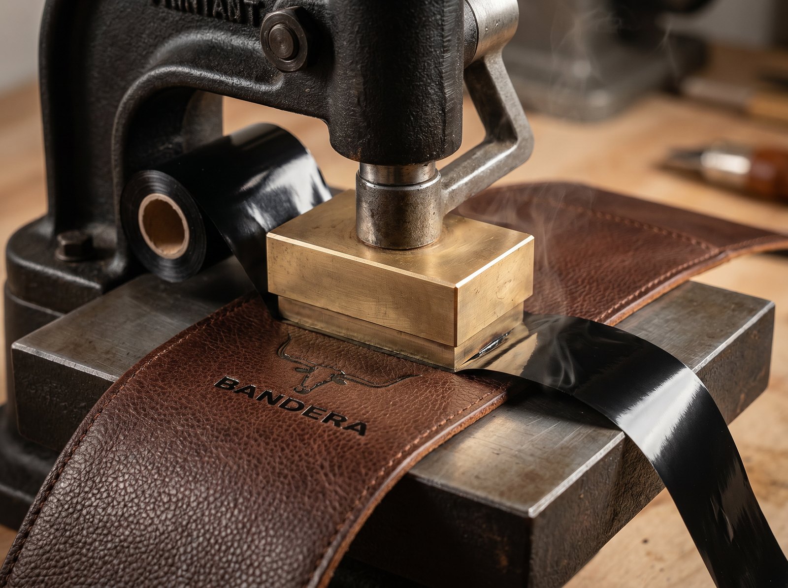 Hot-stamp press laying black foil into Bandera leather